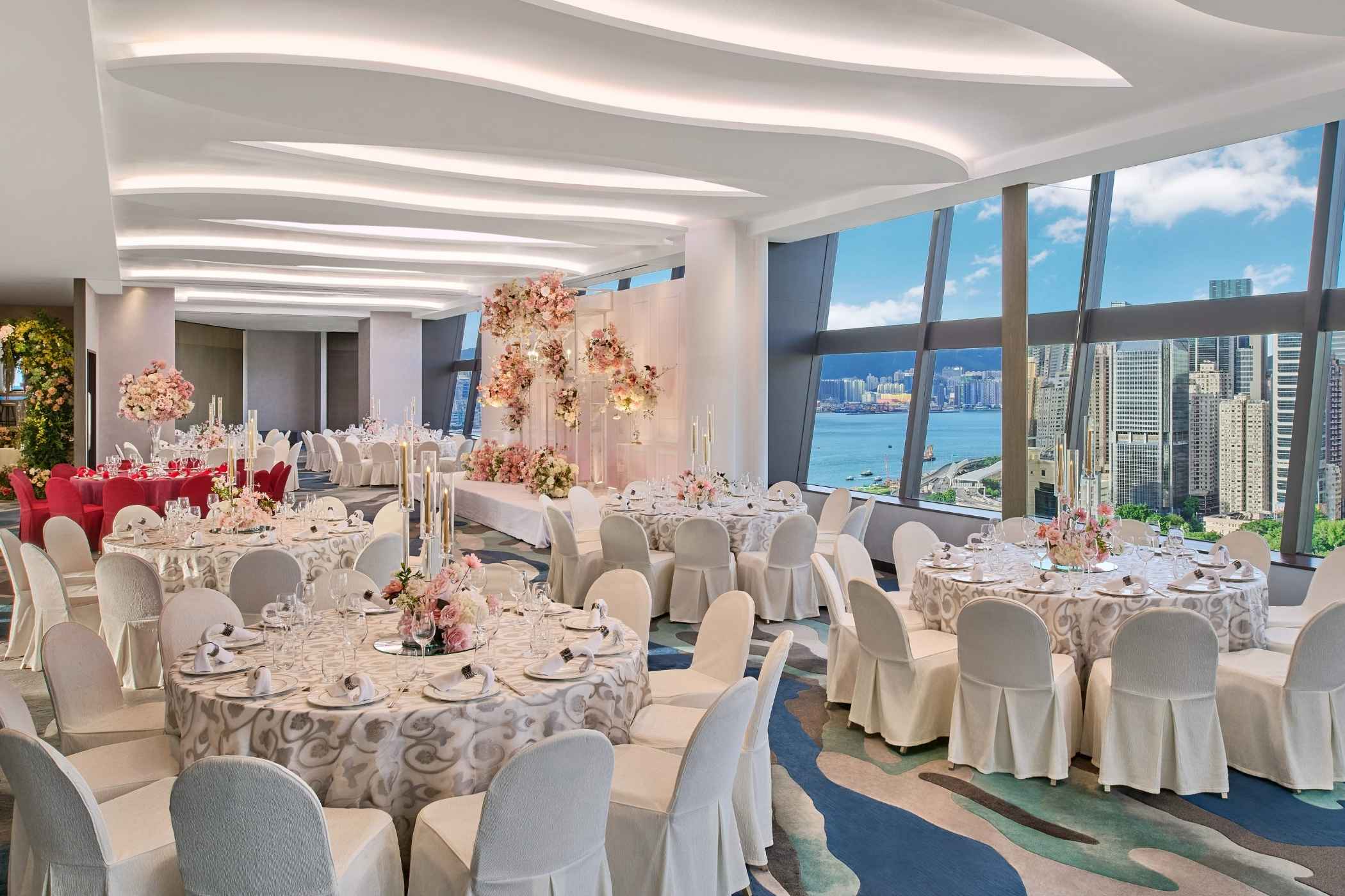 Wedding at the Park Lane Hong Kong, large room with round tables and wedding decorations  overlooking Victoria Harbour